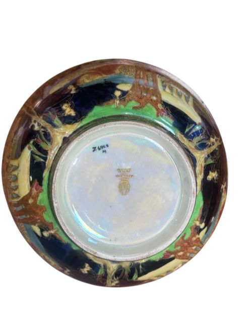 A circular Wedgwood Fairyland Lustre porcelain bowl decorated with vibrant iridescent woodland scenes and fine gold leaf detailing. View VI