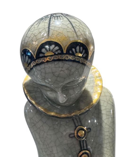 An Art Deco Royal Copenhagen ceramic figurine featuring a crackle pale green glaze with dark blue floral patterns and gilt accents. View V