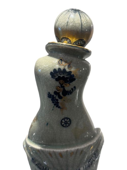 An Art Deco Royal Copenhagen ceramic figurine featuring a crackle pale green glaze with dark blue floral patterns and gilt accents. View VI