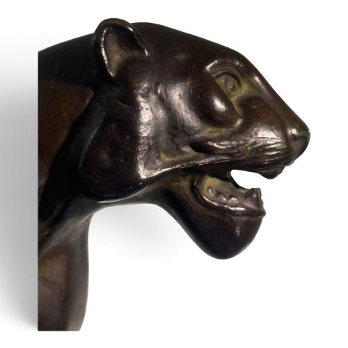 fig 1. A dark patinated bronze panther sculpture depicted in a low prowling stance with an open jaw, mounted on a rectangular marble base.