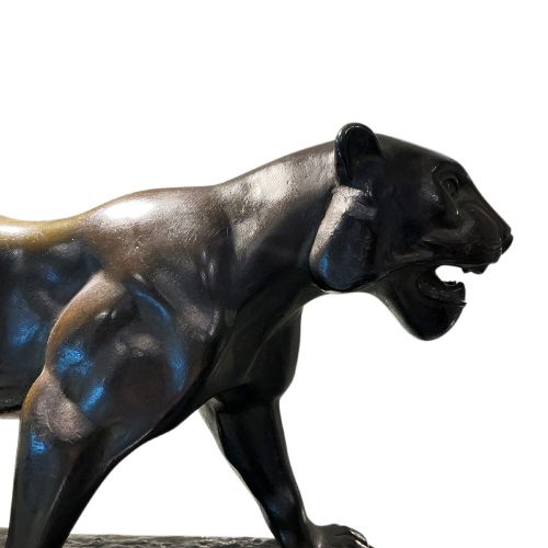 fig 2. A dark patinated bronze panther sculpture depicted in a low prowling stance with an open jaw, mounted on a rectangular marble base.