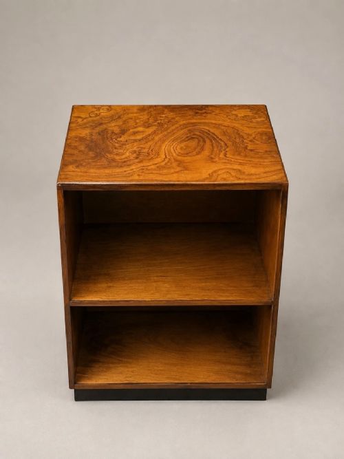 A low 1930s Art Deco ash wood bookcase featuring two open shelves and a contrasting black plinth base. View V