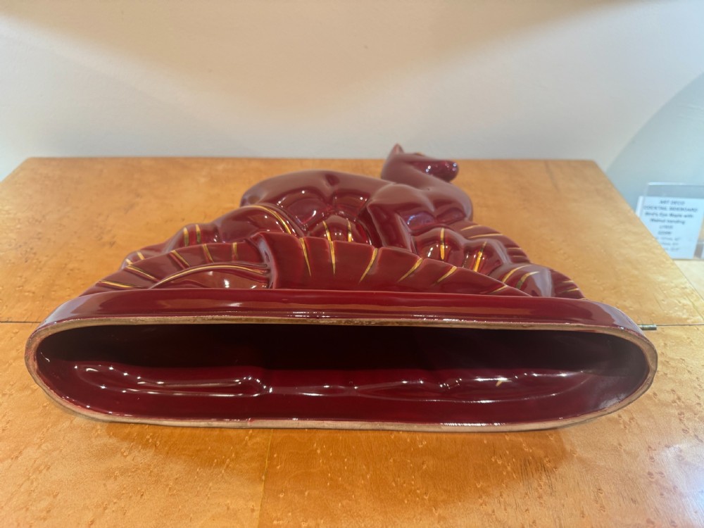 An Art Deco stylised ceramic deer sculpture in a high-gloss maroon glaze featuring gilded accents along the base and eyes. View III