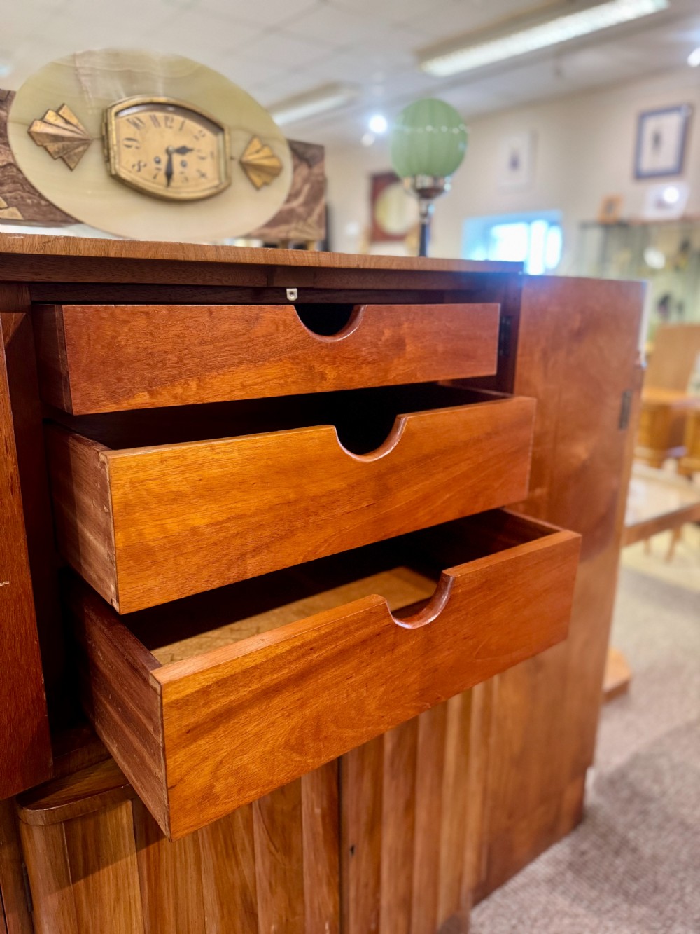 An Art Deco walnut sideboard featuring a stepped silhouette, fluted central cabinet doors, and figured veneer panels. View V