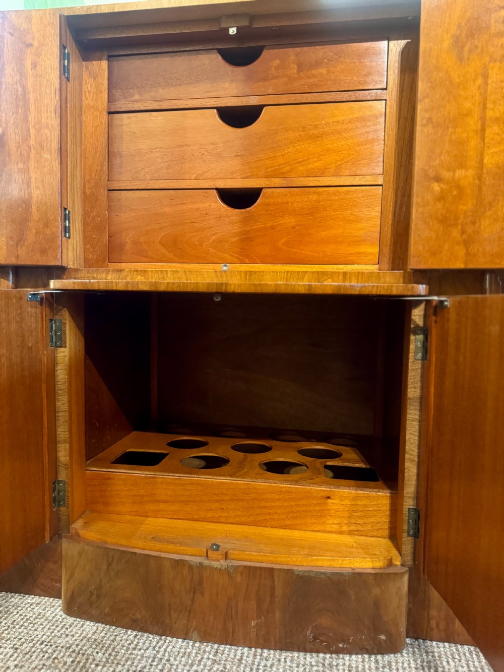 An Art Deco walnut sideboard featuring a stepped silhouette, fluted central cabinet doors, and figured veneer panels. View VII
