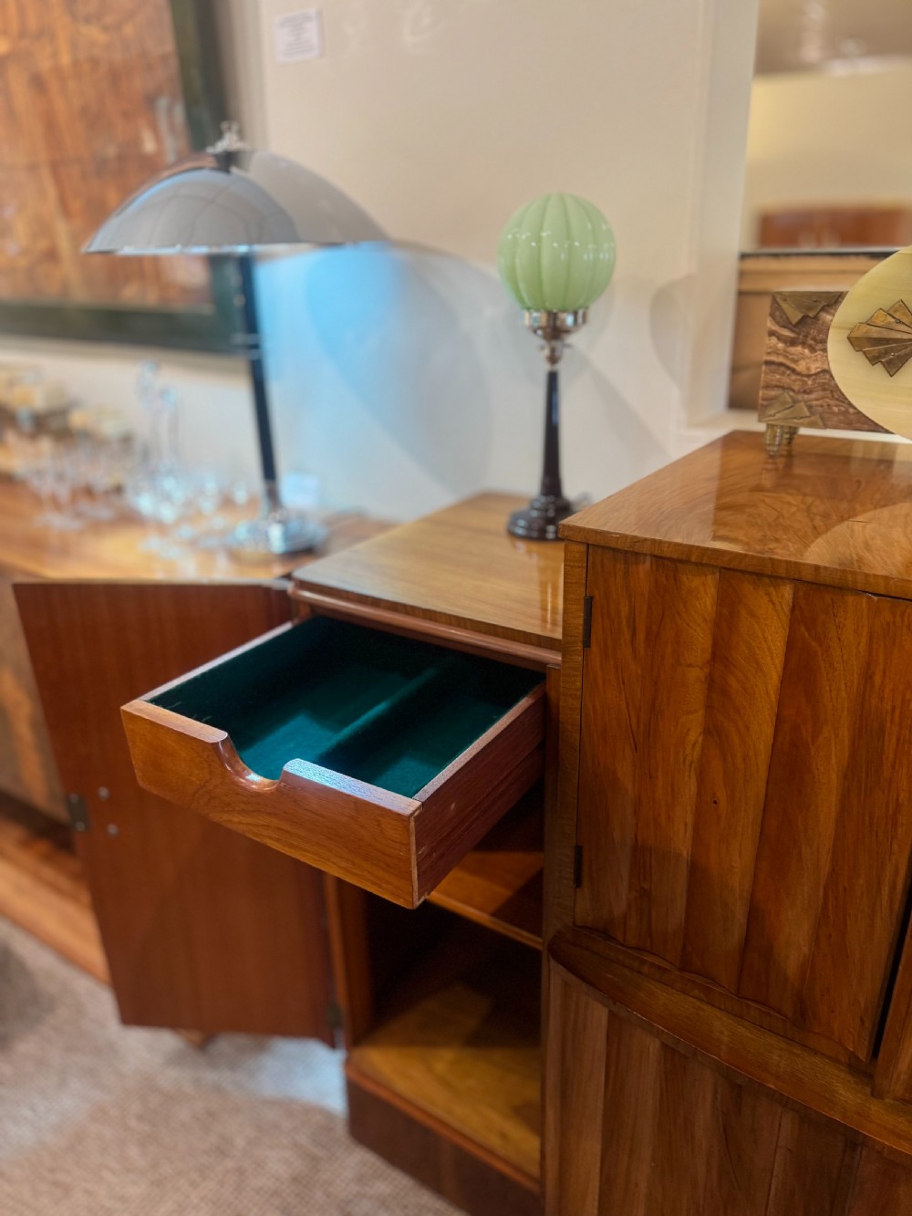 An Art Deco walnut sideboard featuring a stepped silhouette, fluted central cabinet doors, and figured veneer panels. View VIII