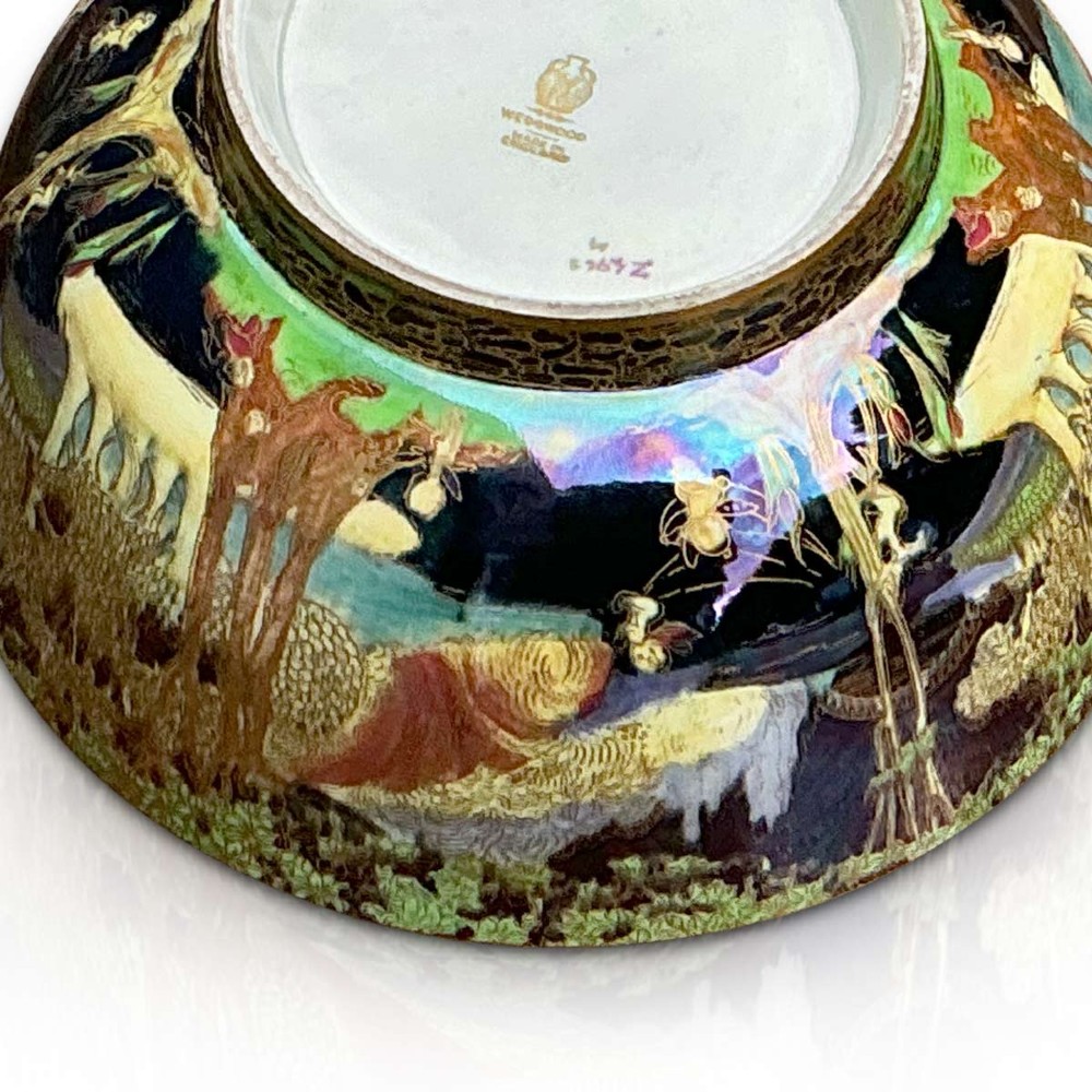 A circular Wedgwood Fairyland Lustre porcelain bowl decorated with vibrant iridescent woodland scenes and fine gold leaf detailing. View II