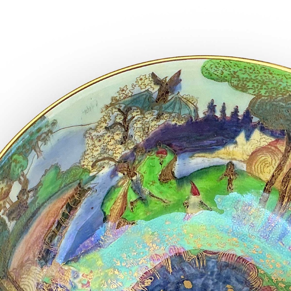 A circular Wedgwood Fairyland Lustre porcelain bowl decorated with vibrant iridescent woodland scenes and fine gold leaf detailing. View V