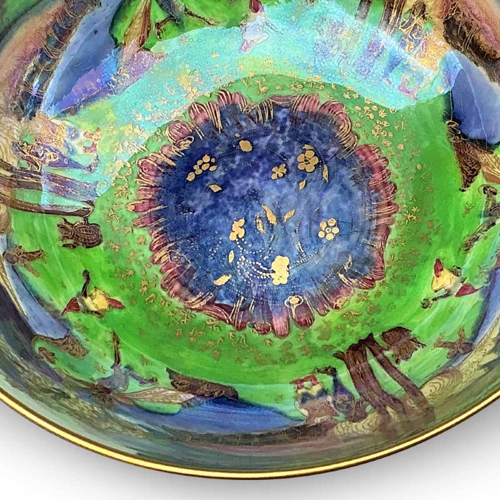 A circular Wedgwood Fairyland Lustre porcelain bowl decorated with vibrant iridescent woodland scenes and fine gold leaf detailing. View VII