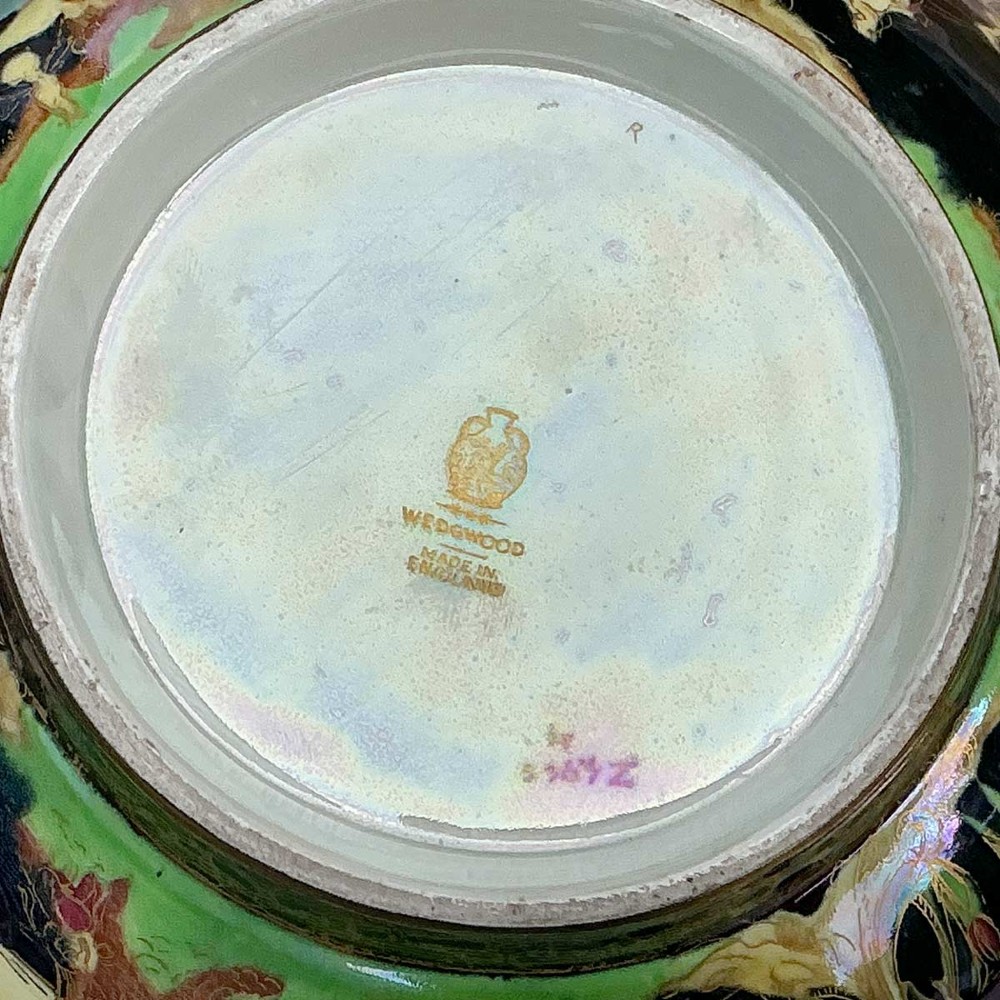A circular Wedgwood Fairyland Lustre porcelain bowl decorated with vibrant iridescent woodland scenes and fine gold leaf detailing. View VIII