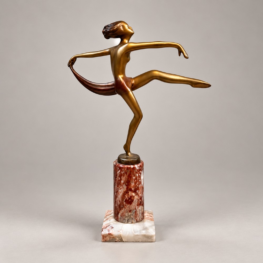 An Art Deco bronzed spelter figurine of a female scarf dancer mounted on a cylindrical variegated marble pedestal. View V