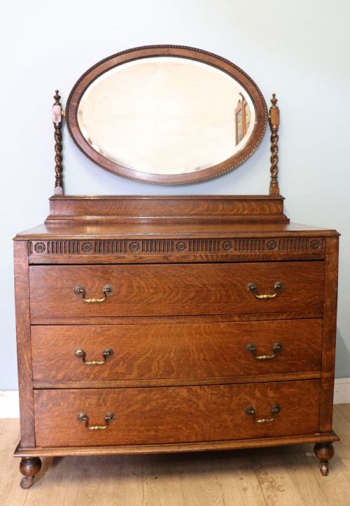 A  Edwardian Oak Dressing Table with an Adjustable Oval Mirror.