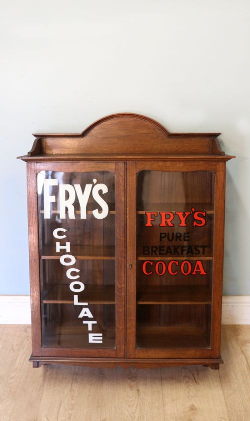 A Wonderful Edwardian Wall Mounted Solid Oak Framed Display Cabinet,  Later Sign Written Advertising Fry's Chocolate.