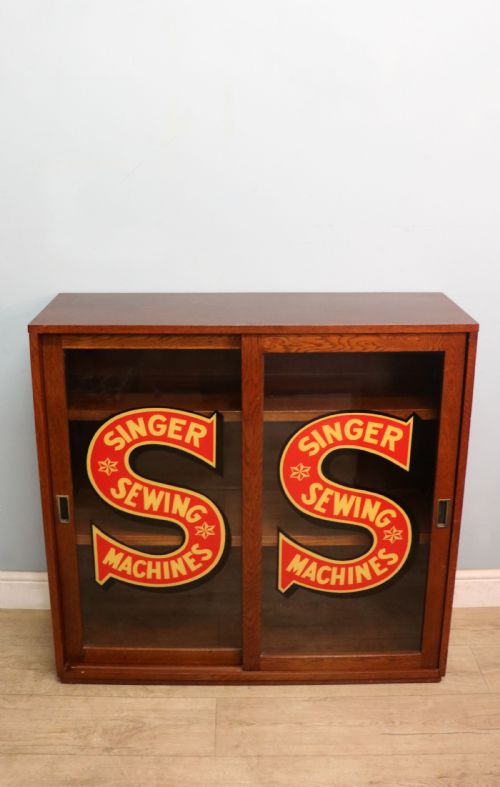 A Lovely Early 20th Century Oak Framed Display Cabinet Sign Written for Singer Sewing Machines.
