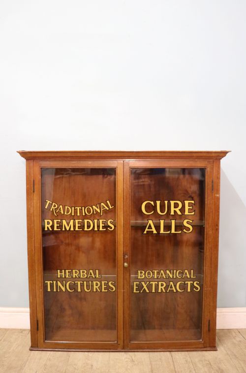 A Early 20th Century Display Cabinet with Later Sign Written a Range of Apothecary Products. 
