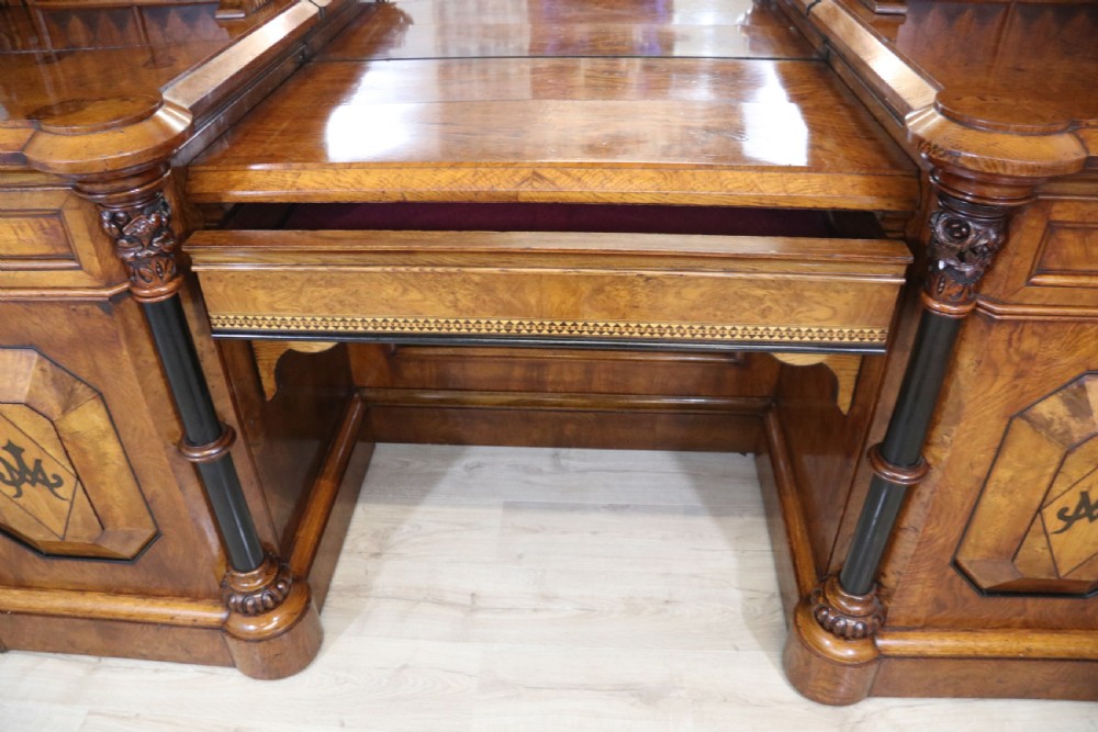 A Victorian Gothic Revival sideboard crafted from pollard oak featuring intricate geometric wood inlays, turned black columns, twin pedestal cupboards, and a tiered upper superstructure. View III