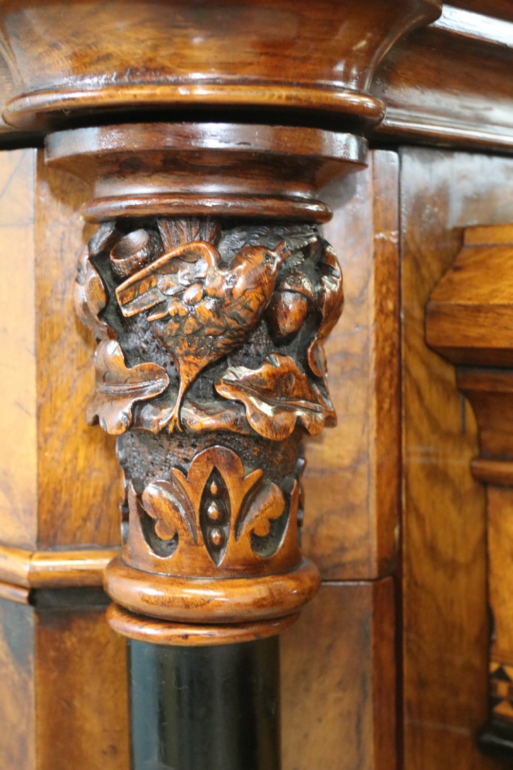 A Victorian Gothic Revival sideboard crafted from pollard oak featuring intricate geometric wood inlays, turned black columns, twin pedestal cupboards, and a tiered upper superstructure. View IV