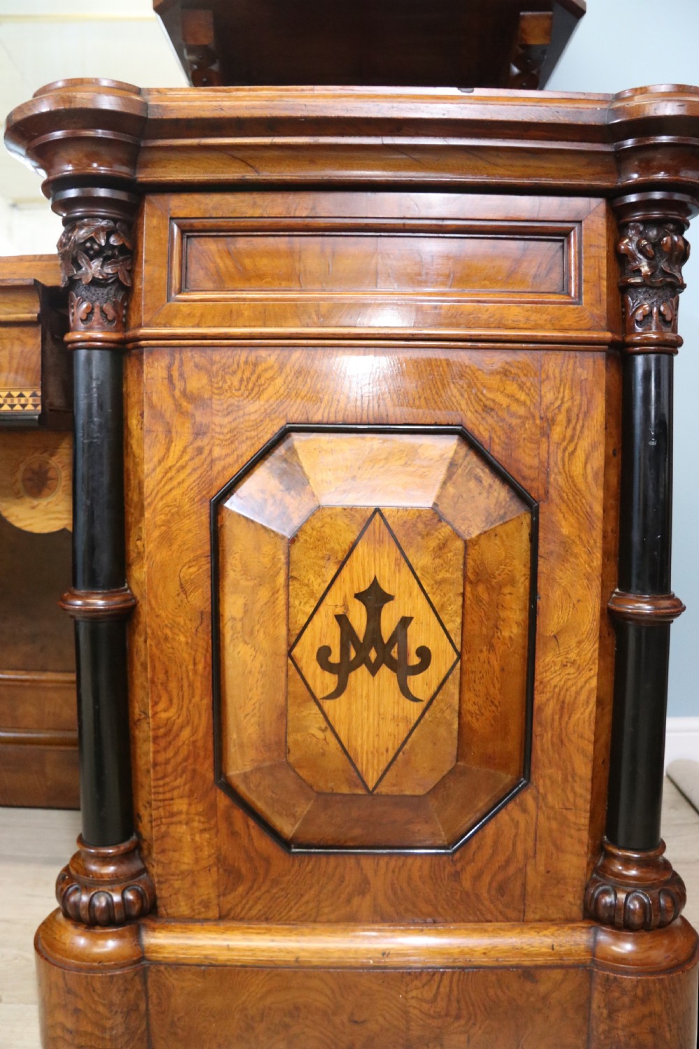 A Victorian Gothic Revival sideboard crafted from pollard oak featuring intricate geometric wood inlays, turned black columns, twin pedestal cupboards, and a tiered upper superstructure. View X