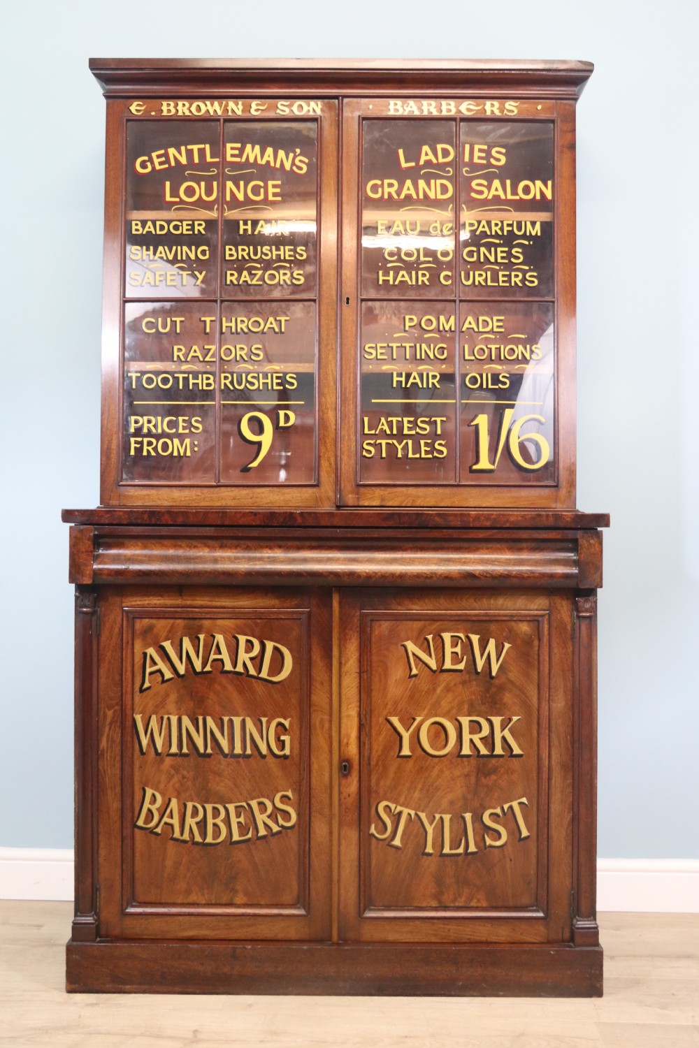 A fine sophisticated Victorian bookcase cabinet with later advertising sign written detail.