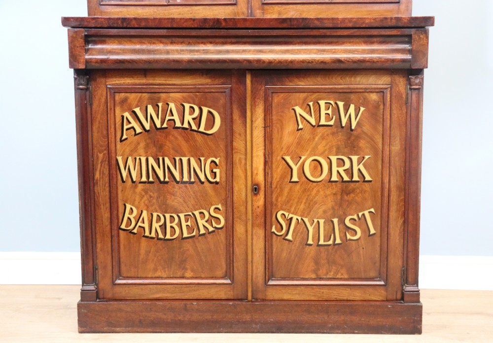A fine sophisticated Victorian bookcase cabinet with later advertising sign written detail. View III