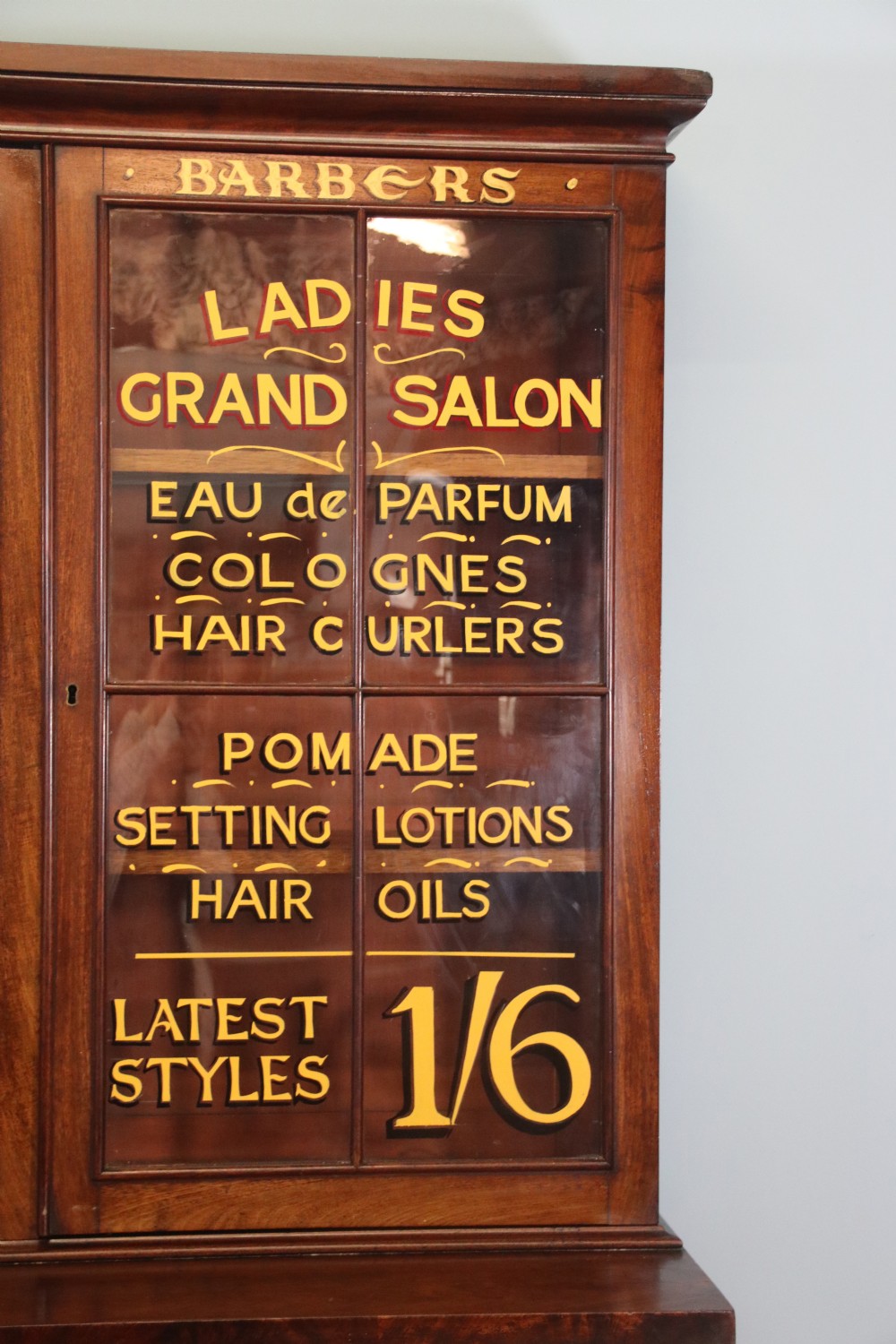 A fine sophisticated Victorian bookcase cabinet with later advertising sign written detail. View V