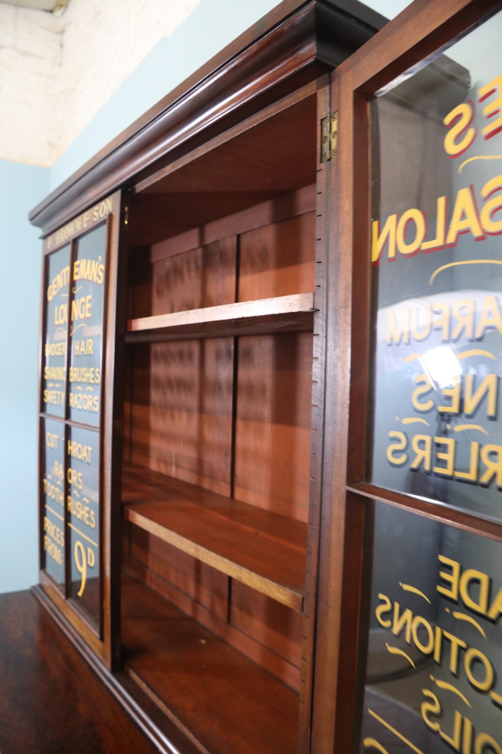A fine sophisticated Victorian bookcase cabinet with later advertising sign written detail. View IX