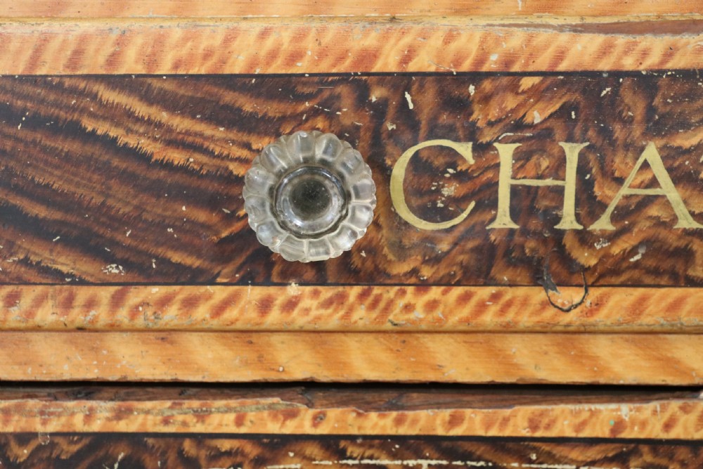 A nineteenth-century French Chateau style walnut sideboard featuring hand-painted French typography, decorative faux-marbling, a carved crest, and glass drawer knobs. View XI