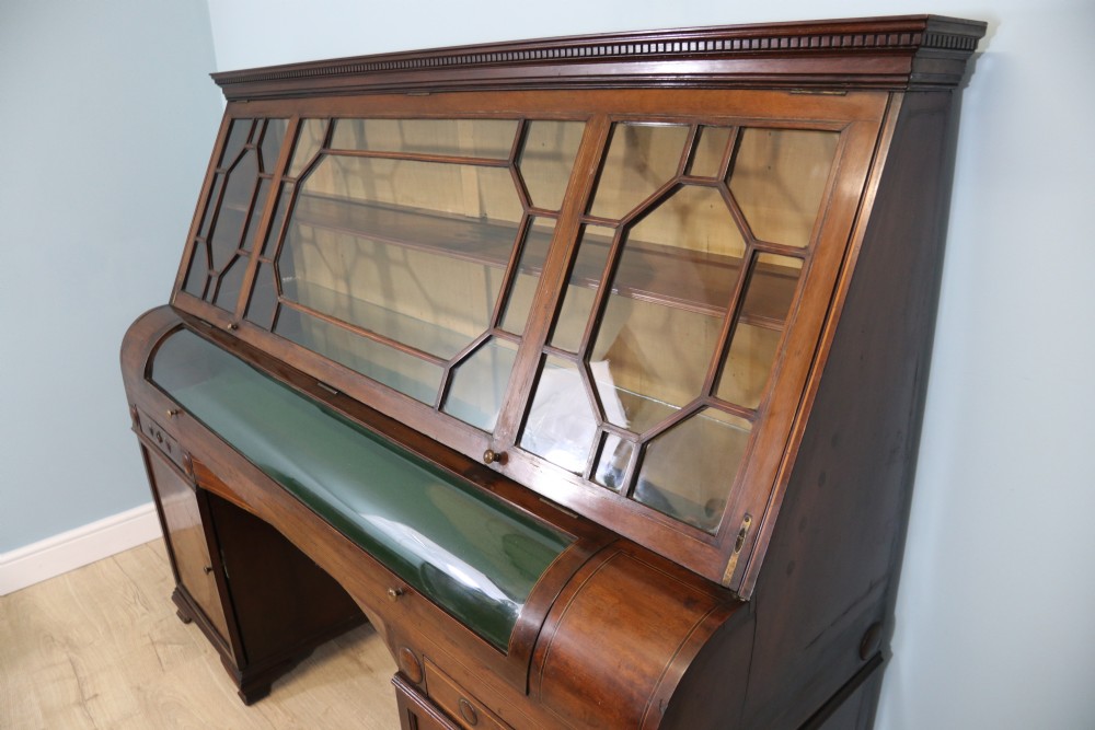 An early nineteenth-century mahogany twin pedestal display cabinet featuring glazed upper doors with geometric glazing bars, a central curved glass display section, and inlaid pedestal cupboards below. View III