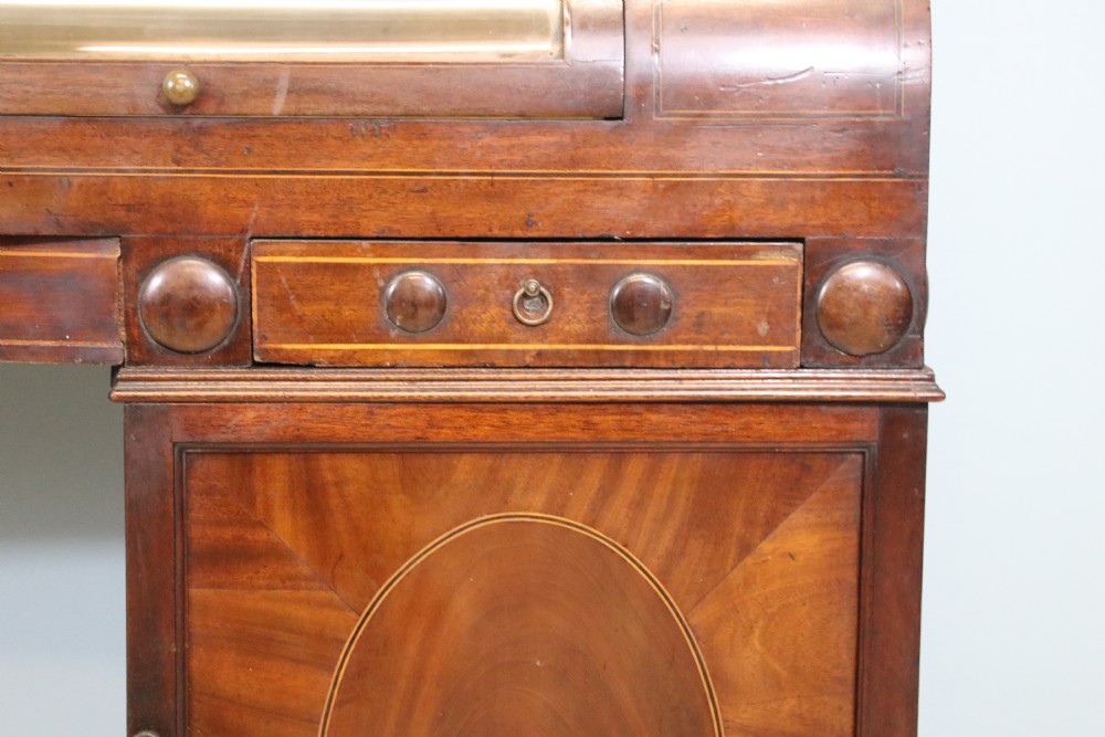 An early nineteenth-century mahogany twin pedestal display cabinet featuring glazed upper doors with geometric glazing bars, a central curved glass display section, and inlaid pedestal cupboards below. View X