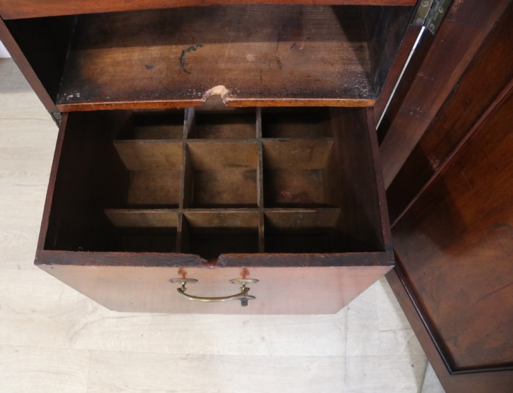 A Victorian mahogany twin pedestal sideboard featuring a central frieze drawer, carved splashback, and flame mahogany cupboard doors on plinth bases. View XIII