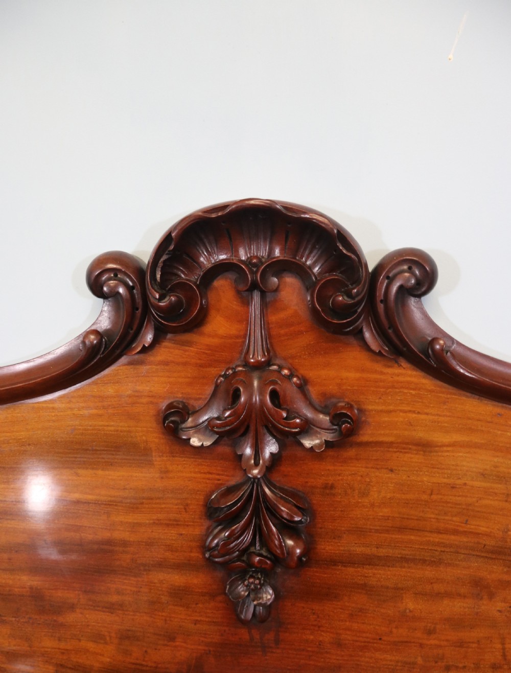 A Victorian mahogany twin pedestal sideboard featuring a central frieze drawer, carved splashback, and flame mahogany cupboard doors on plinth bases. View XIV