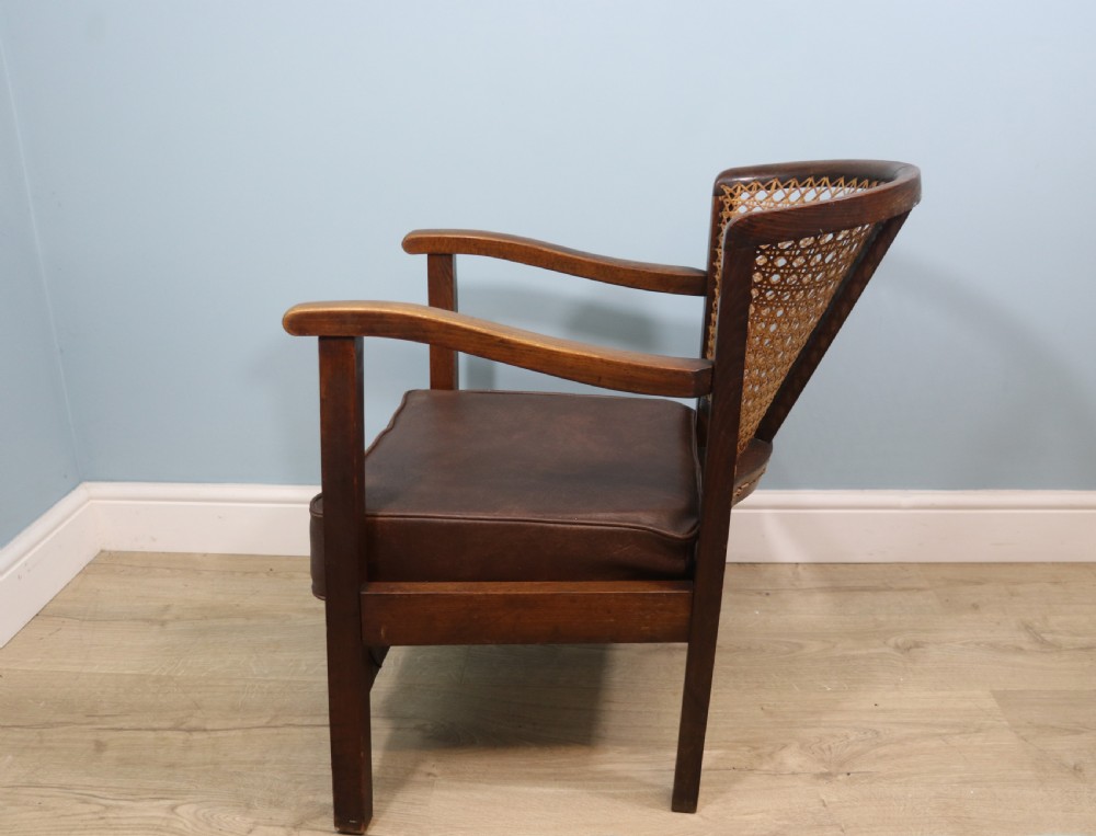 Early 20th century small beech framed cane back bergère chair. View III