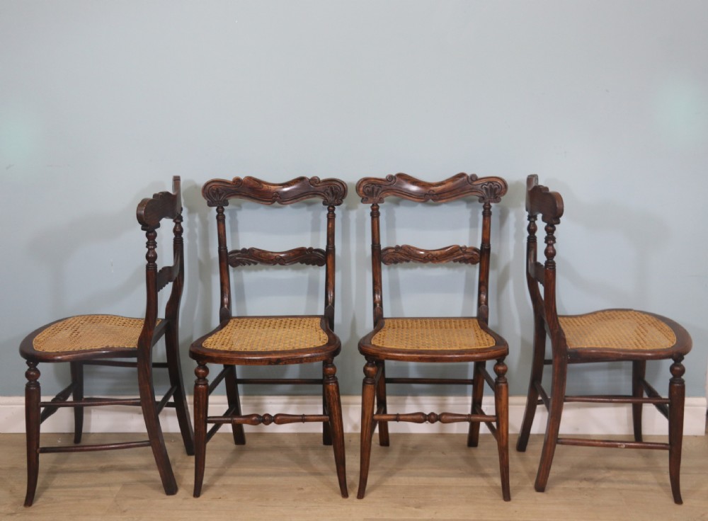  A lovely set of four Victorian hand finished simulated rosewood bar back cane seated chairs