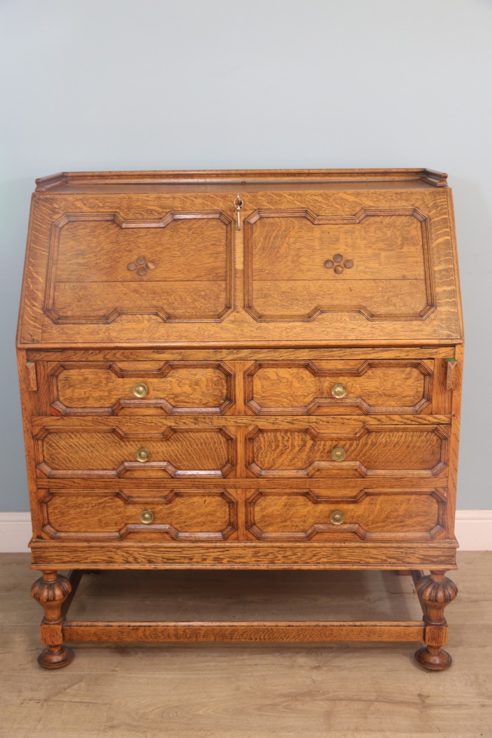 This fine Jacobean revival solid light oak bureau