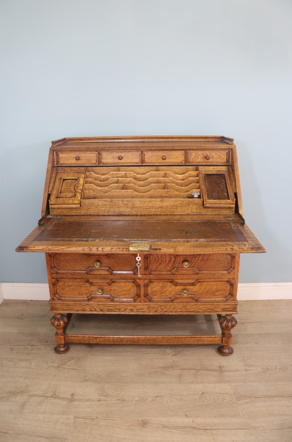 This fine Jacobean revival solid light oak bureau View II