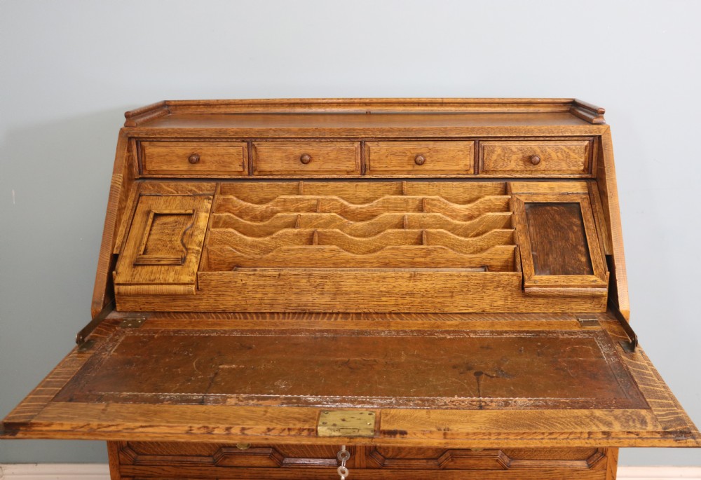 This fine Jacobean revival solid light oak bureau View V