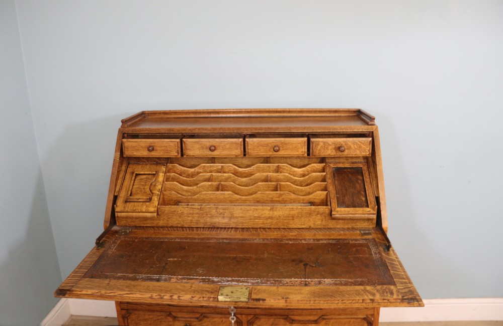 This fine Jacobean revival solid light oak bureau View VI