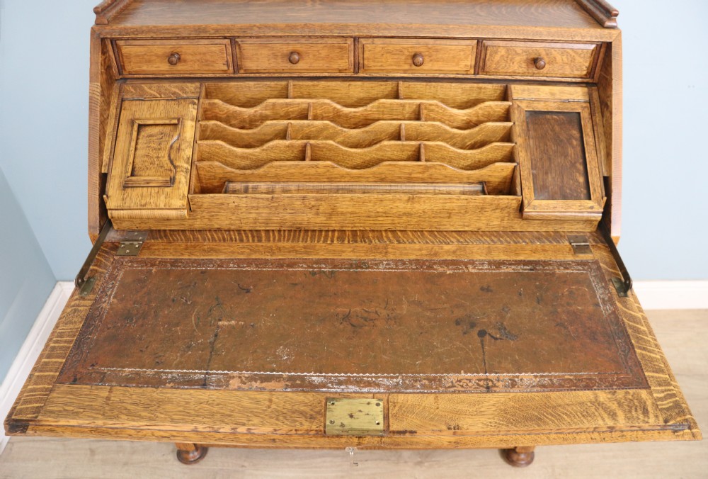 This fine Jacobean revival solid light oak bureau View IX