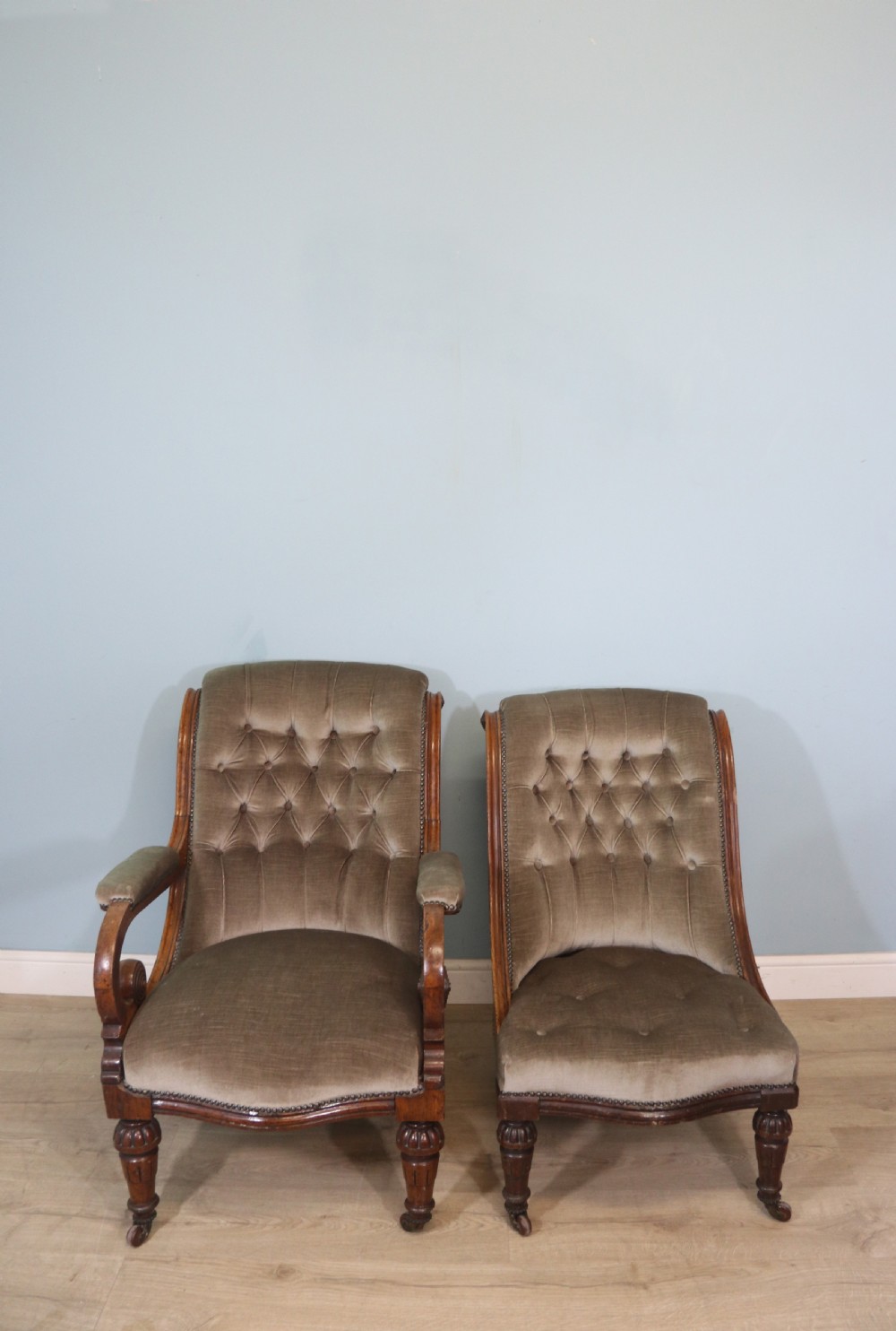 A six-piece late 19th-century chair suite featuring two button-back upholstered armchairs and four matching side chairs upholstered in taupe velvet with turned wooden front legs on castors. View V