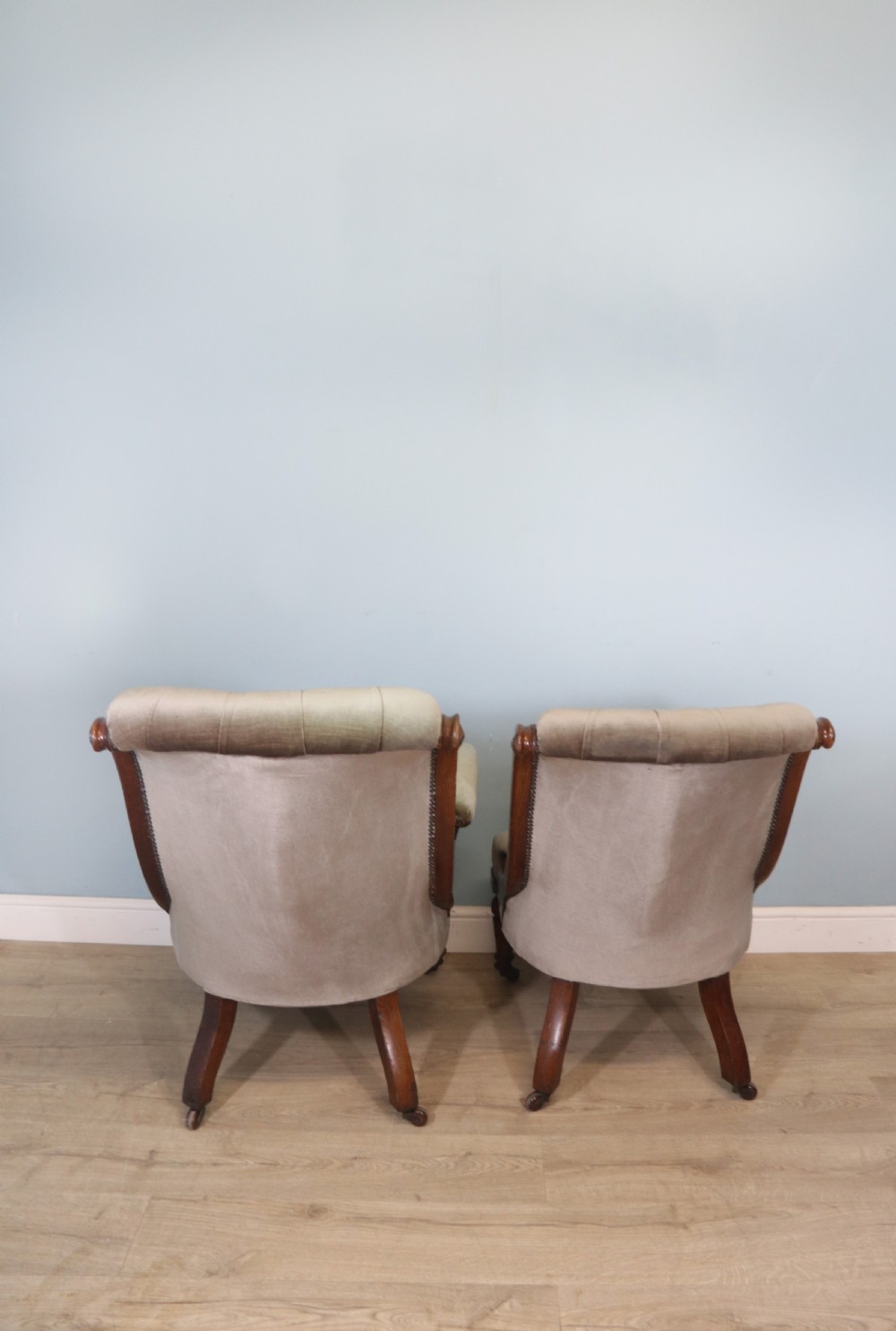 A six-piece late 19th-century chair suite featuring two button-back upholstered armchairs and four matching side chairs upholstered in taupe velvet with turned wooden front legs on castors. View IX