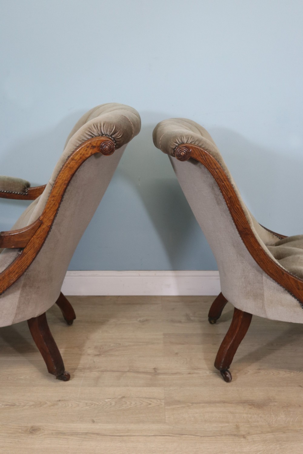 A six-piece late 19th-century chair suite featuring two button-back upholstered armchairs and four matching side chairs upholstered in taupe velvet with turned wooden front legs on castors. View X
