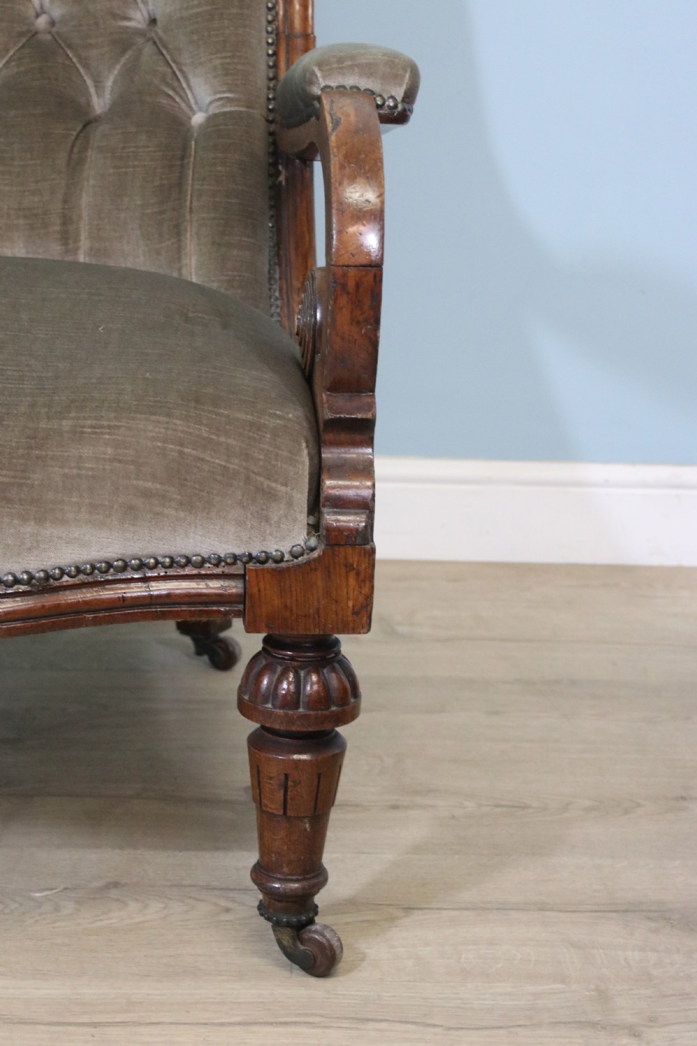 A six-piece late 19th-century chair suite featuring two button-back upholstered armchairs and four matching side chairs upholstered in taupe velvet with turned wooden front legs on castors. View XIX