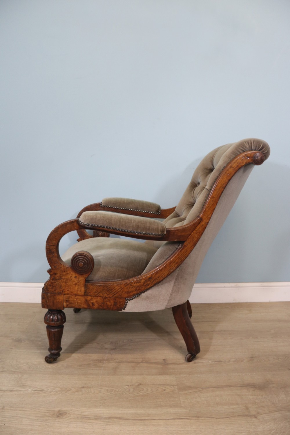 A six-piece late 19th-century chair suite featuring two button-back upholstered armchairs and four matching side chairs upholstered in taupe velvet with turned wooden front legs on castors. View XXI