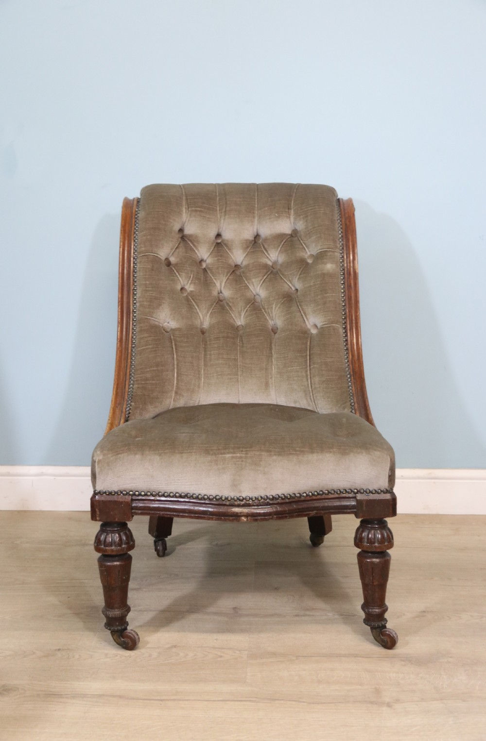 A six-piece late 19th-century chair suite featuring two button-back upholstered armchairs and four matching side chairs upholstered in taupe velvet with turned wooden front legs on castors. View XXIV