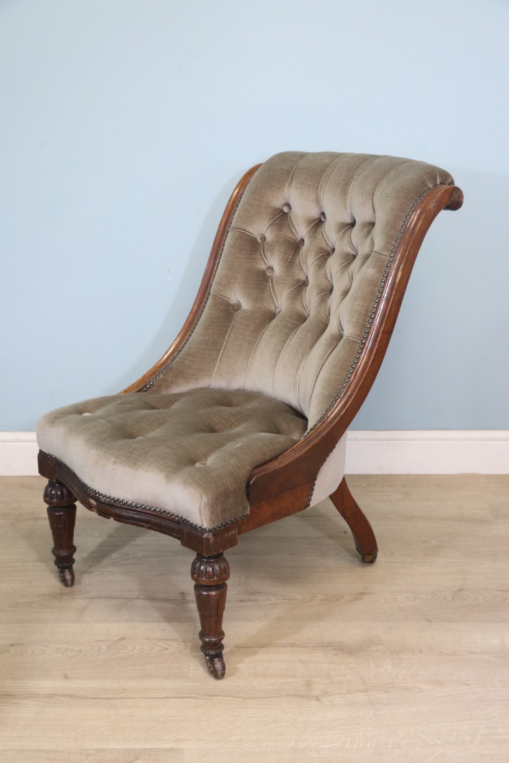 A six-piece late 19th-century chair suite featuring two button-back upholstered armchairs and four matching side chairs upholstered in taupe velvet with turned wooden front legs on castors. View XXV