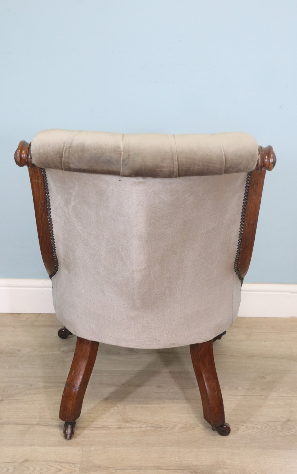 A six-piece late 19th-century chair suite featuring two button-back upholstered armchairs and four matching side chairs upholstered in taupe velvet with turned wooden front legs on castors. View XXVII