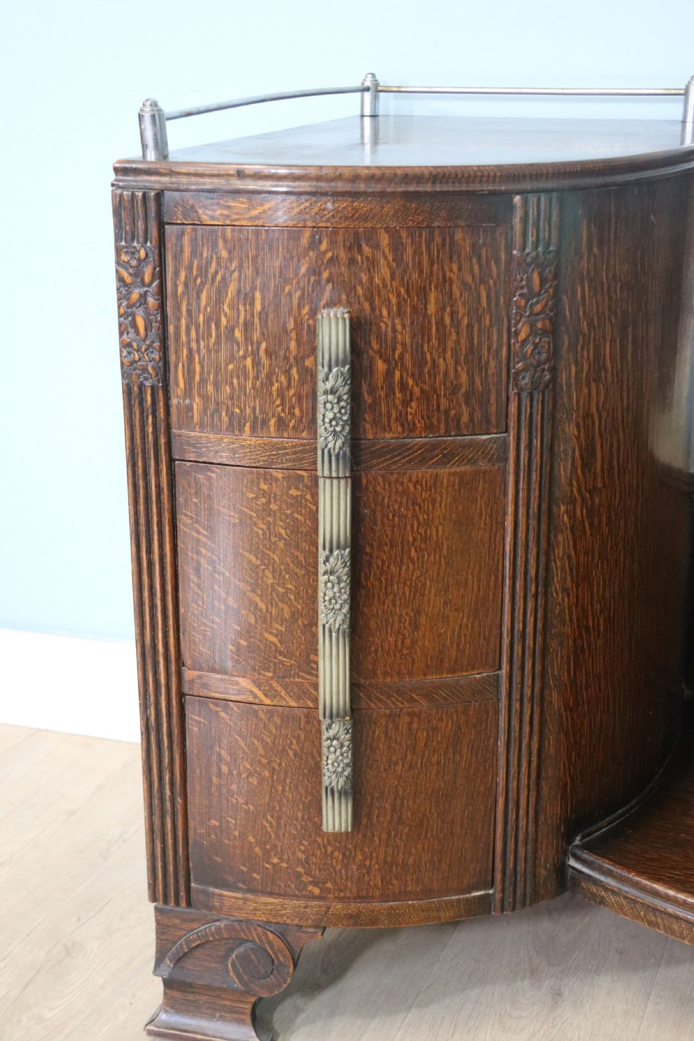 An Art Deco dark oak twin pedestal dressing chest featuring a central full-length arched mirror flanked by two curved three-drawer pedestals with metal gallery rails. View VIII
