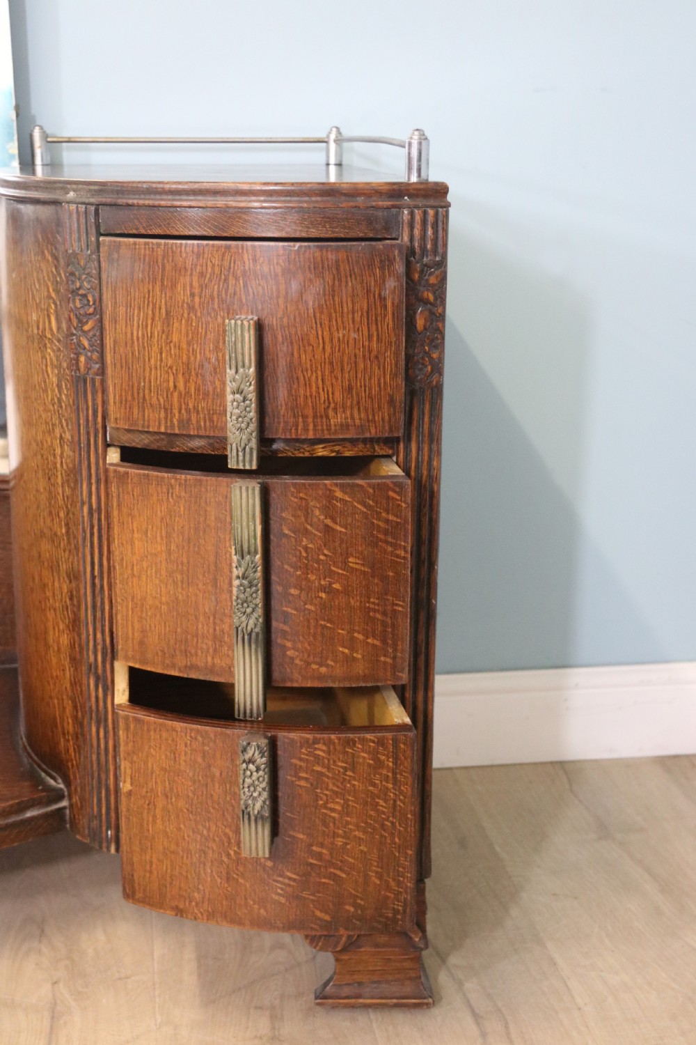 An Art Deco dark oak twin pedestal dressing chest featuring a central full-length arched mirror flanked by two curved three-drawer pedestals with metal gallery rails. View IX