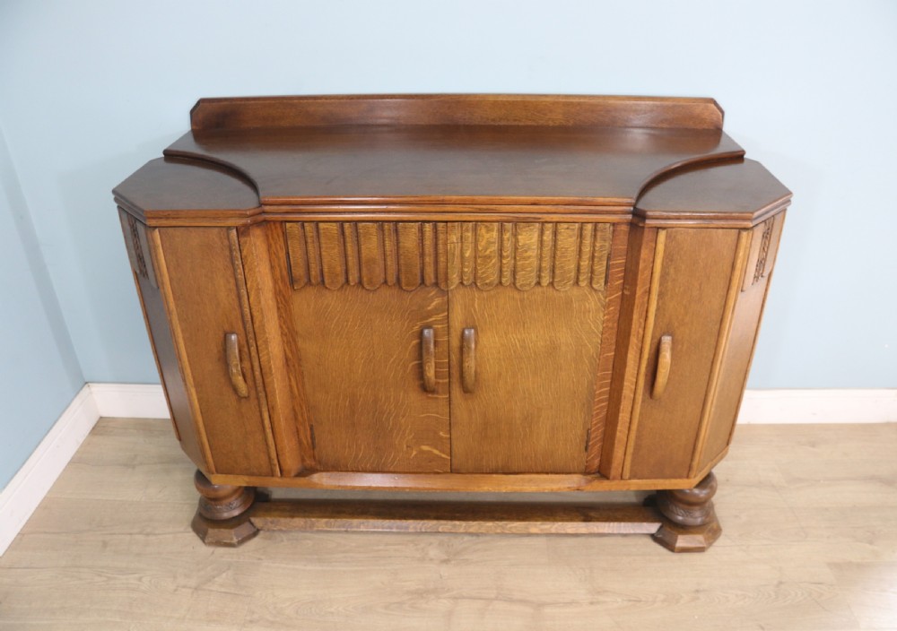 An imposing oak combination drinks cabinet and sideboard