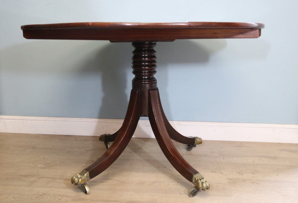 A fine English Antique! A lovely 19th century mahogany oval dining table.  View II
